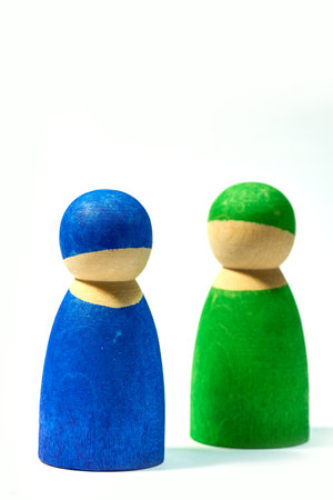 Wood, figure and icon on white background for community, diversity and teamwork with social group. Wooden symbol, studio and friendship with connection, society or abstract people together with colorの写真素材