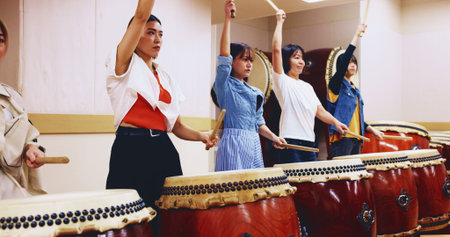 Japanese, drums and women in performance for music on instrument for stage practice, creativity or...