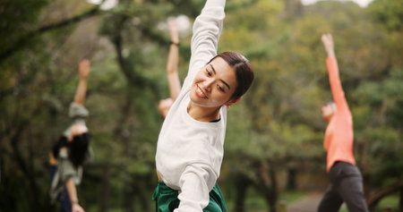 Woman, outdoor nature and warrior at yoga class, meditation and coach support for spiritual wellness. Forest, holistic healing and instructor for fitness in Japan, friends group and zen mindfulnessの写真素材
