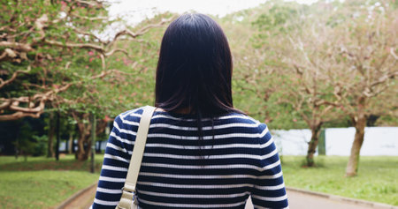 Travel, back and person on vacation, park and adventure for tourist, commuting and exploring of nature. Outdoor, student and tourism of environment, traveller and scenery of destination in Japanの写真素材