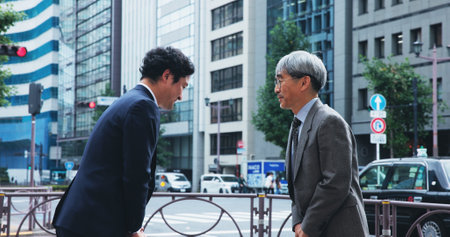 Bow, greeting and Japanese businessmen in city with cultural respect for corporate partnership. Welcome, meeting and male finance executives with ojigi for investment agreement in urban town.の写真素材