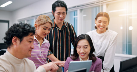 People, tablet or meeting in office for business, company development or positive feedback for growth. Japanese coworkers, happy or tech in consulting agency for problem solving, advice or discussionの写真素材