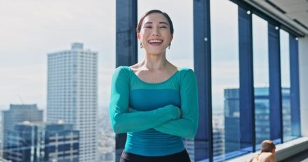 Portrait, Japanese woman and arms crossed in dance studio for practice, training and choreography in...