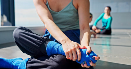 Dancer, hands and stretching foot for fitness, body health and prepare for performance in Japan. Warm up legs, woman and artist in studio for muscle flexibility, wellness exercise and start practiceの写真素材