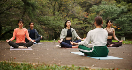 People, outdoor nature and lotus at yoga class, meditation and support women for spiritual wellness. Forest, holistic healing and instructor for fitness in Japan, friends group and zen mindfulnessの写真素材