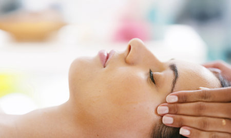 Woman, face or hands with masseuse for spa massage, facial treatment or relaxation at luxury resort. Closeup, female person or therapist with client for lymphatic drainage or stress relief at salonの写真素材