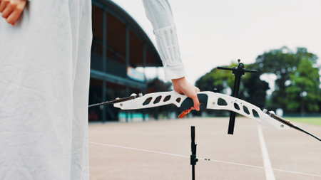 Archery, sport and hands with arrow outdoor for shooting practice, martial arts tradition and game challenge. Japanese culture, person and equipment for kyudo, precision lesson and target trainingの写真素材