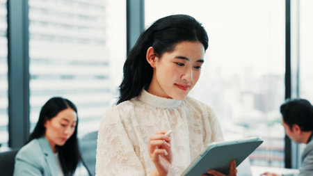 Business, meeting and Asian woman in office on tablet for website, research and project review. Corporate, professional and person on digital tech for planning, internet and email networking in Japanの写真素材