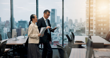 Tablet, window or business people in office with legal advisor for court case, documents or research. Walking, contract or mature lawyer in city with attorney feedback paperwork at law firm in Japanの写真素材