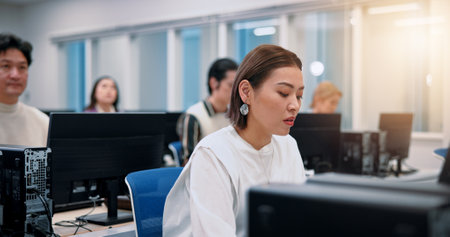 Japanese people, business and computer with office, connection or communication in website support. Woman, coworking and tech for troubleshooting, online database or email as cybersecurity consultantの写真素材