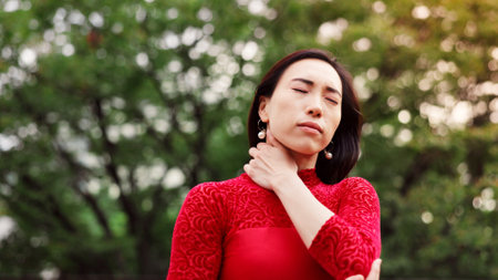 Woman, dancing and neck pain in park with injury, fitness and mistake for performance in nature. Person, ballet and rehearsal for concert with ache, strain or muscle cramp with creativity in Japanの写真素材
