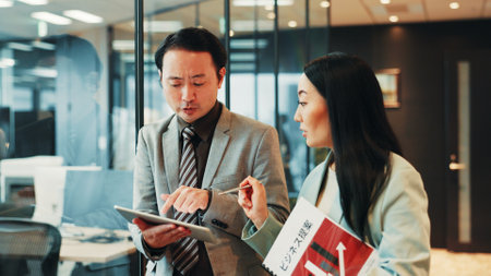Business, walking and people planning with tablet for funding request application, proposal review and feedback. Accounting, employees and digital contract for investment opportunity at Japanese firmの写真素材