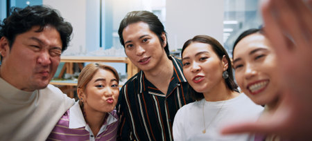 Business, people and selfie with portrait in office for team building memory, collaboration and social media post. Professional, japanese employees and photography with funny face and support at workの写真素材