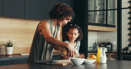 Child, happy mother and breakfast cereal, cooking and health in family home. Mom, hungry kid and prepare food in kitchen, help and parent serve organic morning meal for nutrition, diet and growthの写真素材