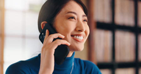 Japanese, woman and home with phone call for communication, listening and banking service for account. House, female person or assistance with mobile conversation for finance enquiry, invest or smileの写真素材