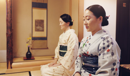 Tea room, guests and women with ceremony, wellness and traditional kimono for culture. Mindfulness, friends and girls with cultural outfit for matcha, tatami and respect for Japanese home hospitalityの写真素材