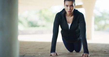 Woman, portrait and fitness with push ups in city for workout, exercise or muscle gain. Active,...