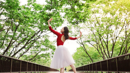 Woman, training and ballet dancing in nature, outdoor and practice performance in park. Female person, professional dancer and creative talent in Japan, rehearsal and urban garden for elegant artの写真素材