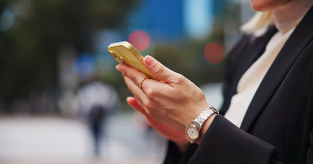 Hands, city and phone with woman on street with social media, job texting and internet scroll in Japan with business commute. Work, digital news and web outdoor with travel with maps app on mobileの写真素材