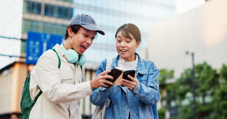 Surprise, phone or Japanese couple in city on location, street or holiday adventure journey in Tokyo. Wow, share or excited people with smile, shock or mobile app for travel trip, navigation or newsの写真素材