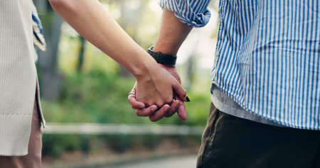 Couple, back and outdoor with holding hands, walk and support for romantic getaway or connection. Woman, man and bonding as together for solidarity, love or weekend as tourist for travel in Indonesiaの写真素材