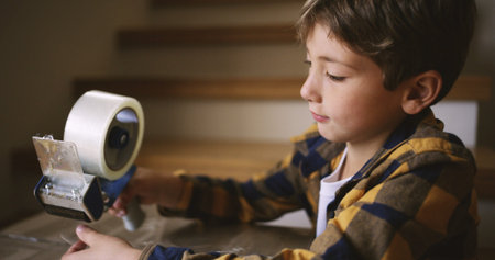 Moving out, tape and child with box, home and packaging of cardboard, property and busy in...