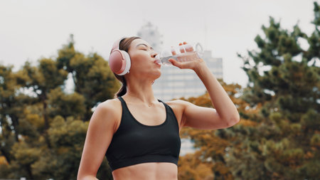 Drinking water, outdoor and woman with fitness, healthy and wellness with workout. Japanese person,...
