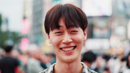 Smile, confidence and portrait of man in city for weekend travel, sightseeing and outdoor adventure. Urban, street and happy face of Japanese student on morning commute with pride, bokeh and cheerfulの写真素材