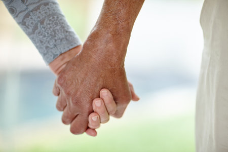 Senior couple, holding hands and love with support for relationship, bonding or care in nature. Closeup, elderly man and woman with touch or help for togetherness, dating or romance in retirementの写真素材