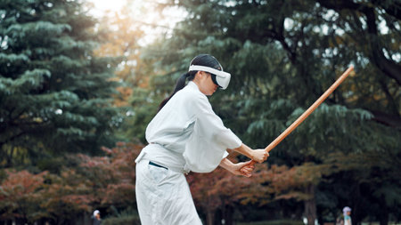 Virtual reality, cyber and Asian woman with sword for martial arts, Kendo practice and exercise. Culture, metaverse and person with shinai, VR tech and goggles for skill, fight and training in Japanの写真素材