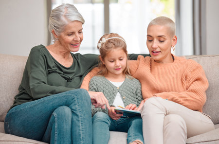 House, grandmother and girl with tablet, mama and typing with smile, bonding together and relax in living room. Family, granny and daughter with tech, mom and digital app with happiness in loungeの写真素材