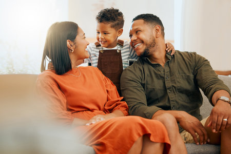 Hug, smile and relax with family on sofa in lounge for love, comfortable and happiness together. Care, bonding and break with parents and child in living room at home for silly, morning and supportの写真素材
