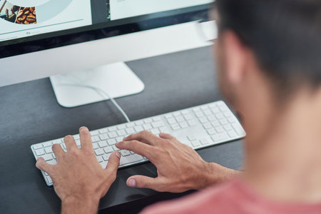 Man, employee and hands on computer keyboard in office, work and copywriter online for research. Male person, professional and email client for planning agenda, project management and website reviewの写真素材