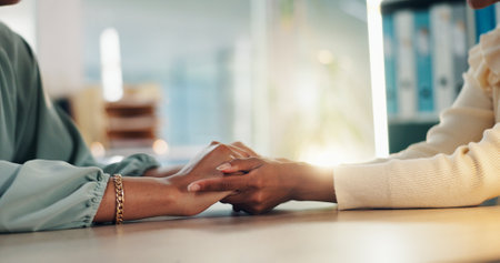 People, hands or empathy with consultation for talk, understanding or counseling therapy at office. Closeup, therapist or patient with touch for sympathy, emotion or support for grief, loss or adviceの写真素材