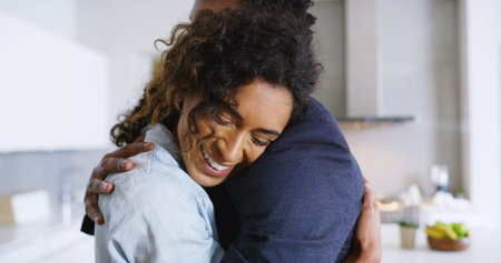 Love, embrace and happy couple in home with reunion, trust or comfort in kitchen together for...