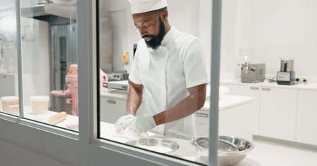 Cooking, bakery and dough with black man in kitchen for coffee shop, food industry and meal prep....