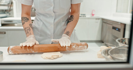 Rolling pin, bakery and dough with hands of person in kitchen for coffee shop, food industry and meal prep. Cooking, chef and nutritionist with baker closeup in restaurant for pastry, cafe and flourの写真素材