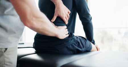 Back pain, physiotherapy and hands with people in clinic for deep tissue pressure, tension and...