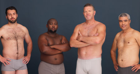 Diversity, body positivity and portrait of men in underwear with confidence, inclusion and unique identity in studio. Support, solidarity and male friends with pride, arms crossed and grey backgroundの写真素材