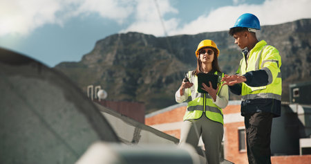Woman, man and engineering with air conditioning on roof, discussion and tablet for inspection in city. People, technician and partnership with review for hvac repair, planning or application in townの写真素材