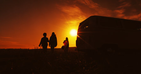 Road trip, silhouette and sunset with friends outdoor together for holiday, travel or vacation. Countryside, dark and vehicle with group of people in nature park for adventure, camping or journeyの写真素材