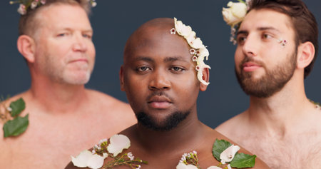 Beauty, studio and portrait of men with flowers for cosmetics, wellness and spa aesthetic. Salon,...
