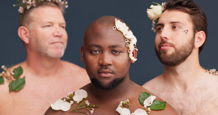 Beauty, skincare and portrait of men with flowers in studio for cosmetics, wellness and background. Diversity, lgbtq and queer people with plants for natural skin, self confidence and aestheticの写真素材