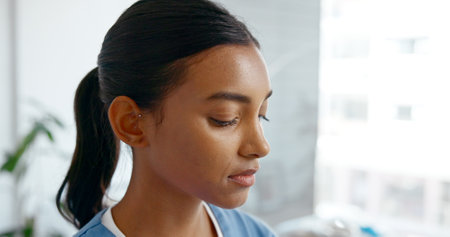 Woman, doctor or face with grief, loss or mistake in hospital building thinking of crisis. Frustrated, Indian or sad medical healthcare physician with stress, depression or failed surgery at clinicの写真素材