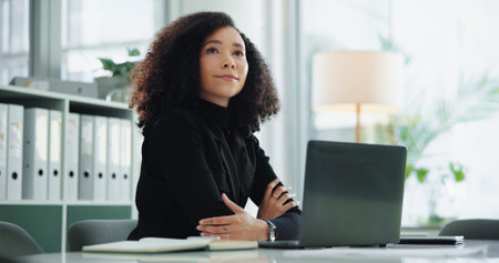 Laptop, thinking and woman in office with ideas, smile and budget solution at accounting agency. Consultant, accountant or businesswoman at desk with financial planning for online business reportの写真素材