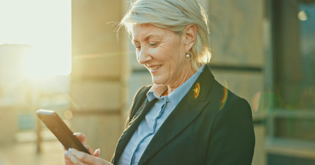 Woman, city lawyer and phone for networking, chat and online for consulting on legal case. Female person, urban town and travel to office building for justice, counsel client and message on appの写真素材