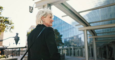 Travel, business woman and thinking in city for insight, vision or back view. Decision, planning and mature manager outdoor with idea, solution and inspiration for real estate development opportunityの写真素材