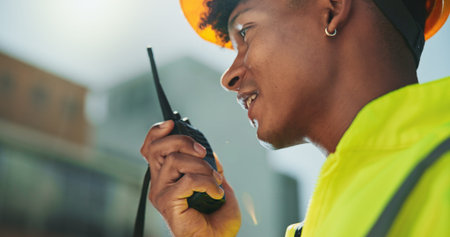 Radio, construction and man talking in city for communication, contact and maintenance. Civil...