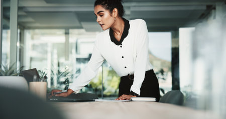 Boardroom, laptop and secretary with woman getting ready for meeting preparation in corporate office. Computer, setup and start with employee person in workplace for professional developmentの写真素材