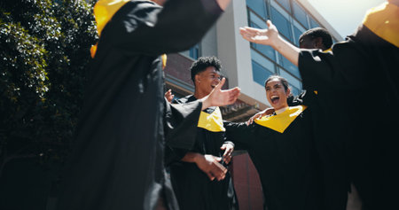Celebration, education and graduation with group of students outdoor on college or university...